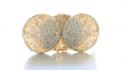 Crispy round buckwheat and rice snack on white table with shadow. Heathy way to replace the...