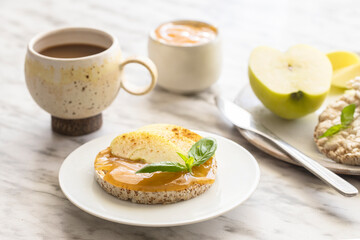 Sweet breakfast. Crunchy buckwheat and rice snack with almond butter and apple on the table. Healthy food concept