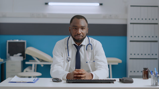 Pov Of African American Therapist Doctor Listening Remote Patient During Online Videocall Meeting Confrence In Hospital Office. Physician Man Explaining Medication Treatment. Telehealth Call Concept