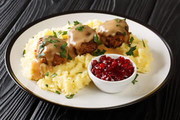 Scandinavian Meatball Lihapullat with mashed potatoes and lingonberry jam close-up in a plate on the table. Horizontal