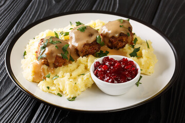 Scandinavian Meatball Lihapullat with mashed potatoes and lingonberry jam close-up in a plate on...