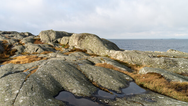 Beautiful view of the archipelago in northern Gothenburg, Öckerö. Sunny day, warm light, blue sky and sea, nice cliffs in the foreground. Place for text, copy space.