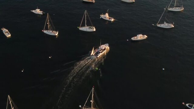 Ship sailing between yachts, vessels and boats parked in the atlantic ocean