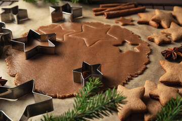 Christmas gingerbread dough in the cooking process on a dark background.