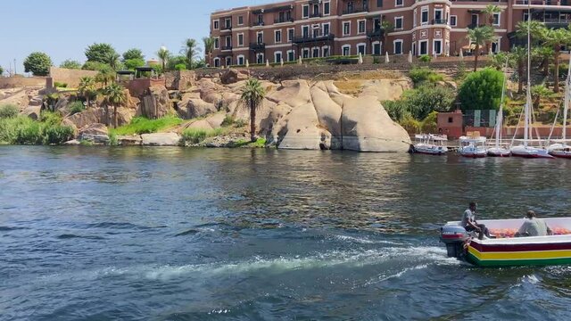 Motorboat crossing in front Old Cataract Hotel in Aswan, Egypt. Accommodation where Agatha Christie stayed during the writing of the book Death on the Nile¨.