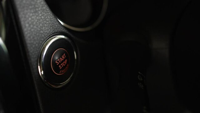 Finger press the button to start the car engine.