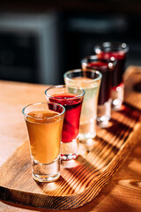 Various assorted alcohol shot drinks on the wooden bar desk
