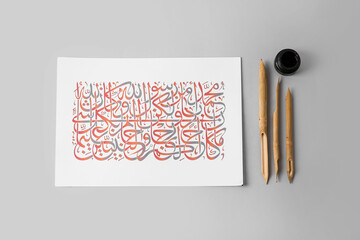Paper with Arabic text and tools for calligraphy on light background - obrazy, fototapety, plakaty