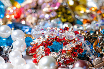 necklaces, earrings, bracelets, pearls, beads and various colored gemstones as a background