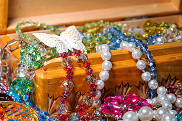 jewelry box, pearl beads and various other multicolored jewelry, soft focus, prosperity concept