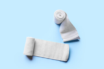 Elastic bandage rolls on color background