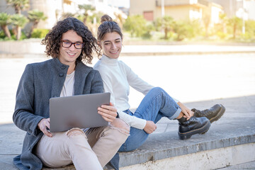 young couple sitting with laptop and learning