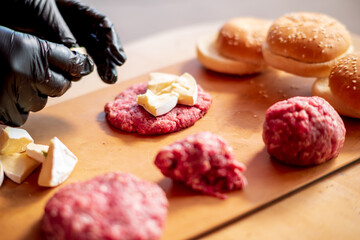 Male chef cook preparing homemade burger.