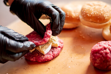 Male chef cook preparing homemade burger.