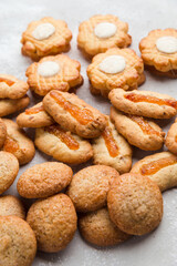 Heap of different small cookies on the grey background