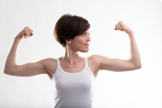 Young woman flexing her arms for showing her biceps muscles