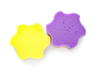 Purple and yellow star shaped bath sponges on white background