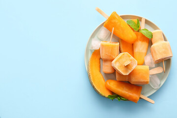 Plate with tasty melon popsicles on color background