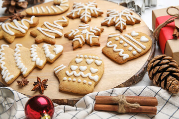 Board with Christmas gingerbread cookies on white wooden background