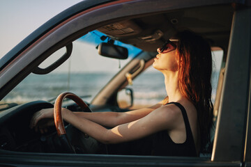 pretty woman in sunglasses driving a car trip