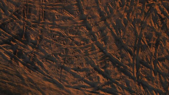 Lots of traces of car tires on the sand. Textured pattern on the sand. Aerial photography top view