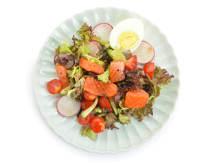 Tasty salad with salmon, egg and fresh vegetables in plate on white background