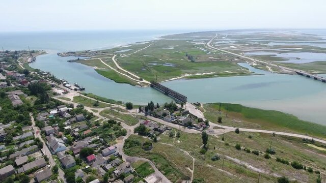 Aerial shot of Arabat arrow with a grate bridge, local road, village and water