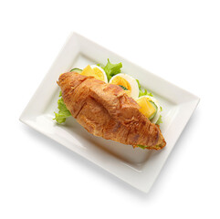 Plate with delicious croissant sandwich on white background