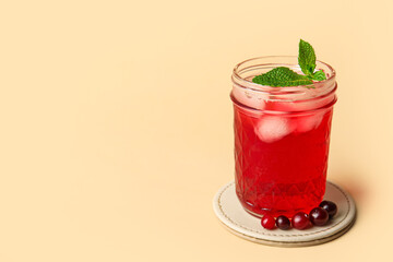 Glass with healthy cranberry juice on color background