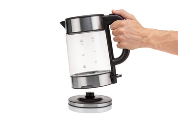 A hand holds a glass, electric, modern transparent kettle on a white background. Close-up.