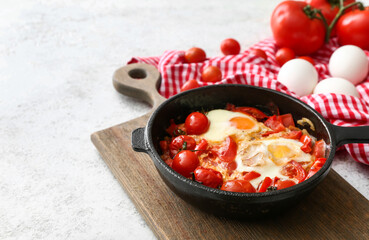 Frying pan with tasty Shakshouka on light background
