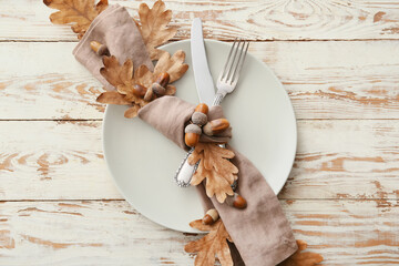 Stylish autumn table setting on light wooden background