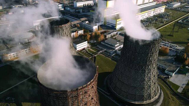 Electricity production by burning coal. A coal-fired power plant ejects a cloud of steam. Environmental impact of human impact on the environment