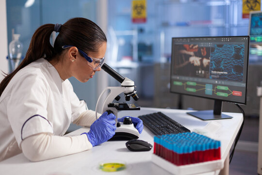 Specialist doctor analyzing virus expertise using microscope during biomedical experiment in hospital laboratory, Biologist researcher working at vaccine development. Healthcare treatment