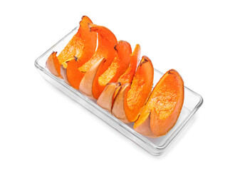 Dish with baked pumpkin pieces on white background