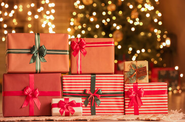 Many Christmas presents on floor in room at night