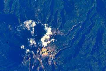 Clouds over a mountain. Digital Enhancement. Elements of this image furnished by NASA