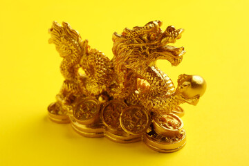 Figurine of Chinese dragon on color background