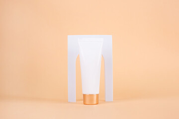 White Cream tube mockup on white podium with arch on beige background.