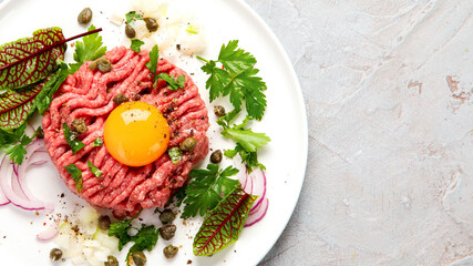 Beef steak tartare on light background. French cuisine concept.