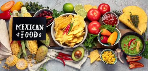 Mexican dishes and snacks assortment on light gray background.