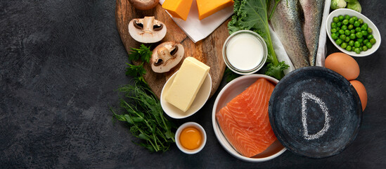 Foods high in vitamin D on dark background.
