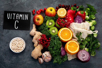 Foods high in vitamin C on dark background.