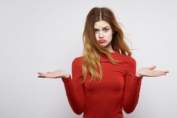 cheerful woman in red dress posing luxury hand gesture isolated background