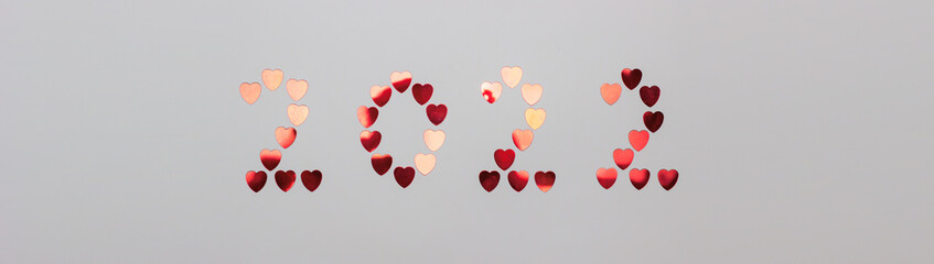 New year and christmas, valentine's day 2022. Inscription from shiny red hearts on a white background.