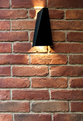 Brick wall with shining lamp and ray