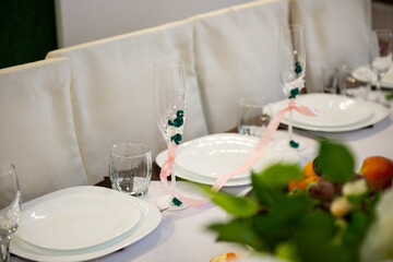 three empty eating places in restaraunt prepared for guests at wedding feast at celebration table