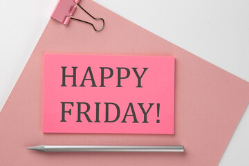 Pink sticker on pink paper with pencil on a white background with text HAPPY FRIDAY