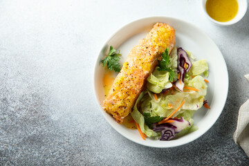 Baked salmon with orange sauce and salad