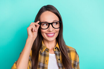 Photo of hr young brunette lady look empty space wear spectacles yellow shirt isolated on turquoise color background
